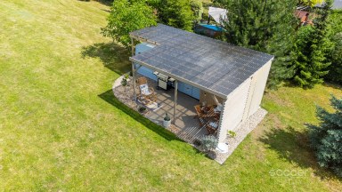 Příjemná venkovská zahrada s rekreačním karavanem a terasou.